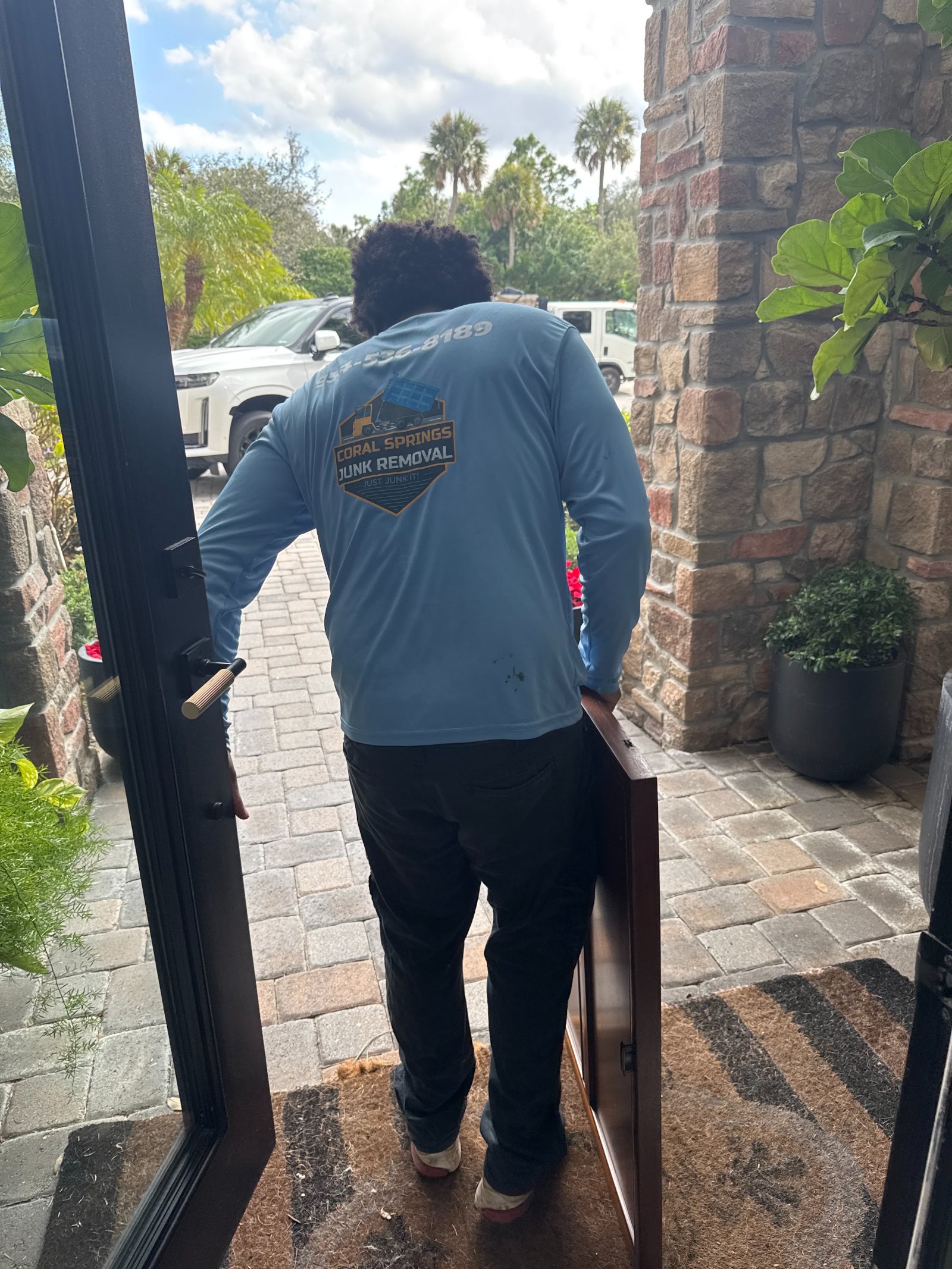 Crew carrying furniture out of a home in Coral Springs FL